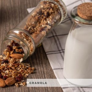 Granola in jar on side with bottle of milk