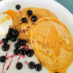 oat pancakes on plate with berries